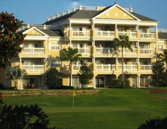 Front view of a multi-story residential building with balconies.