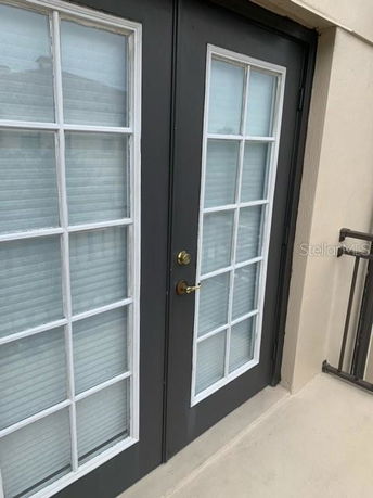 Exterior view of a double glass door with white frames.