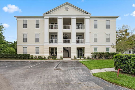 Front view of a multi-story building with a columned entrance.