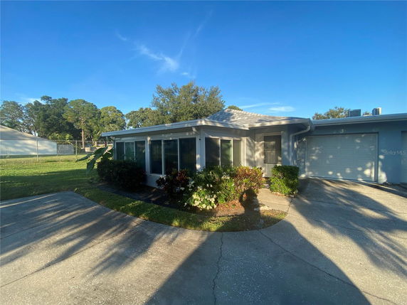Front view of a single-story house with a driveway and garage.