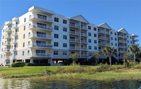 Front view of a multi-story apartment building with balconies.