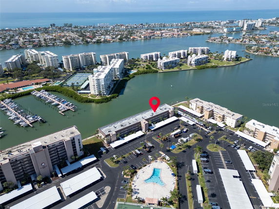 Panoramic view of residential buildings near water with surrounding area.