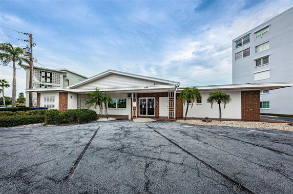 Front view of a building with a gabled roof and brickwork.