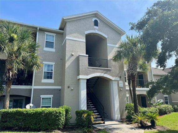 Front view of a multi-story residential building with exterior staircases.
