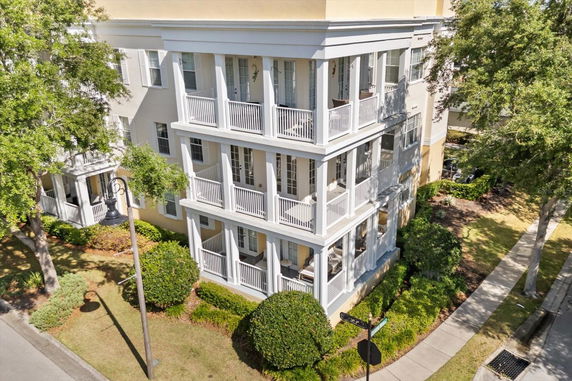 Front view of a multi-story building with balconies on each floor.