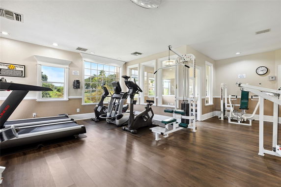 Fitness room with exercise machines and weights.