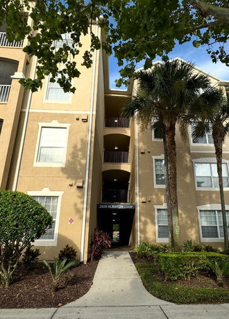 Front view of a multi-story apartment building with a central entrance.