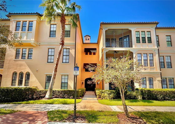 Front view of a multi-story residential building with balconies.