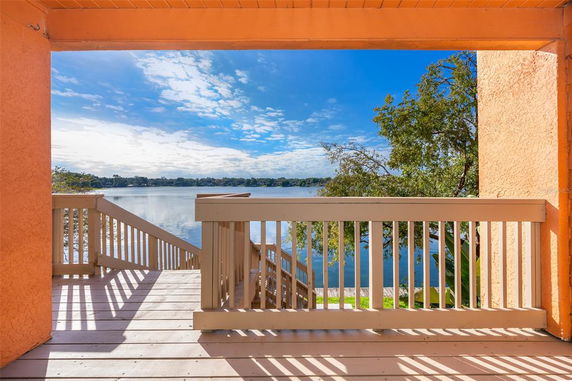 Panoramic view of a lake and surrounding landscape seen from a building.