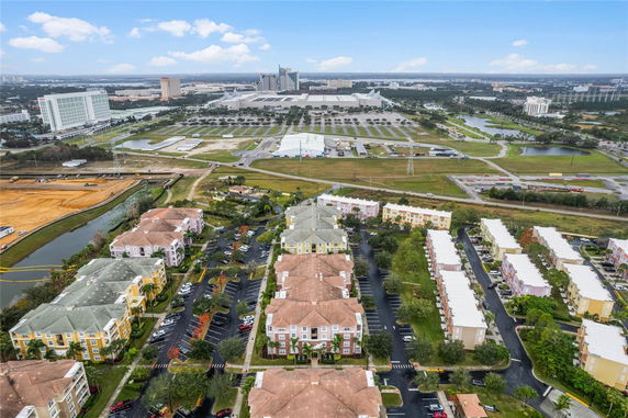 Aerial view of a residential complex with multiple buildings and parking areas.