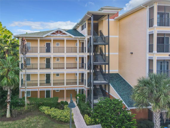 Front view of a multi-story apartment building with external staircases.