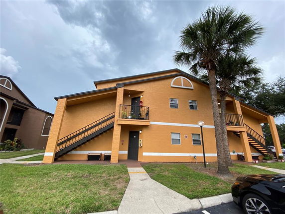 Front view of a two-story residential building with external staircases.