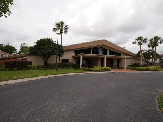 Front view of a single-story building with a modern architecture and a sloped roof.