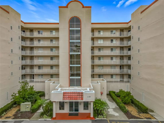 Front view of a multi-story building with balconies.