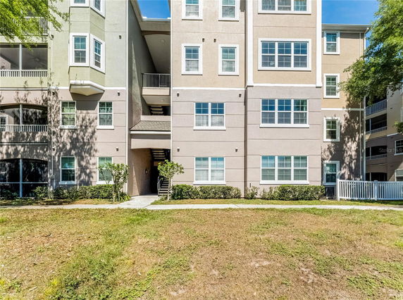 Front view of a multi-story apartment building with multiple windows.