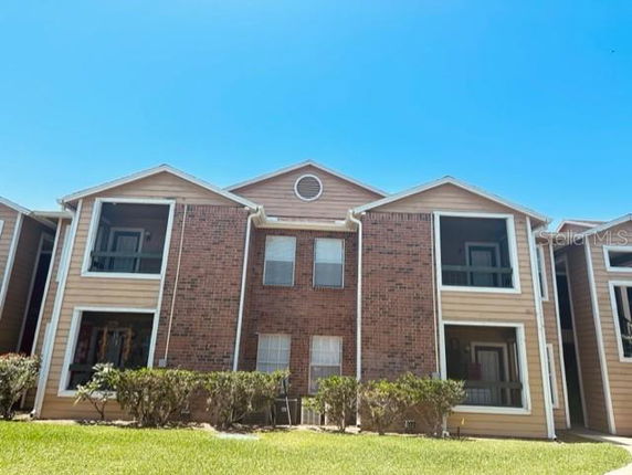 Front view of a two-story building with brick and siding exterior.