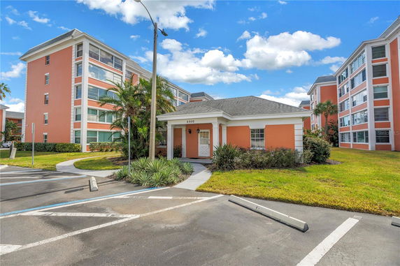 Front view of a residential building with multiple floors, featuring a prominent entrance area.
