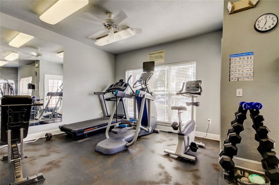 Interior view of a fitness center with exercise equipment.