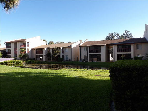 Front view of a multi-story residential building with balconies.