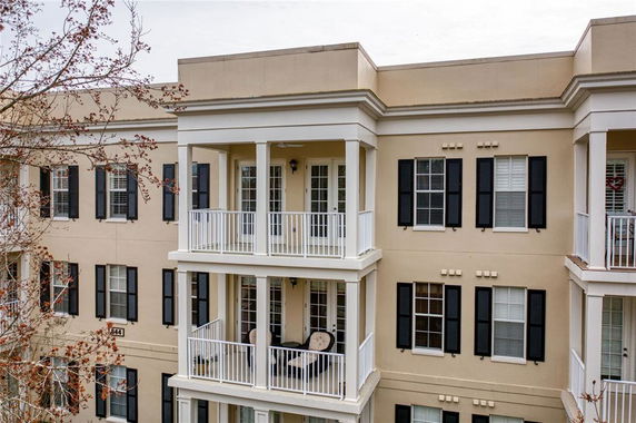 Front view of a multi-story apartment building with balconies.