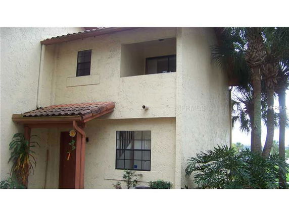 Front view of a two-story house with small overhang and balcony.