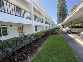 Front view of a two-story building with balconies and a covered walkway.