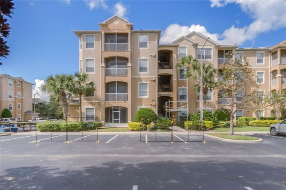 Front view of a multi-story residential building with balconies.