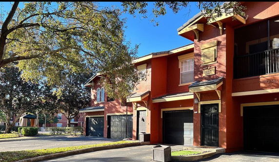 Front view of a two-story residential building with garages.