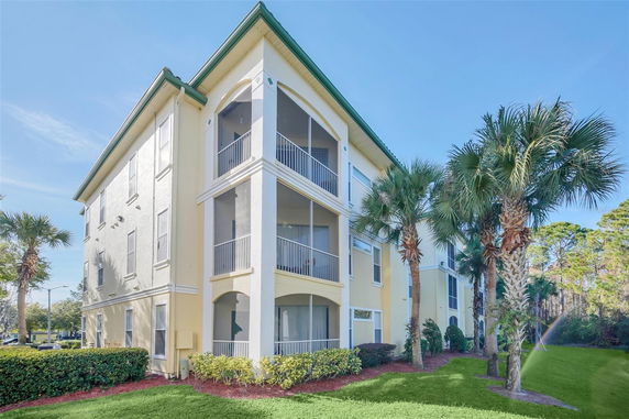 Front view of a multi-story residential building with screened balconies.