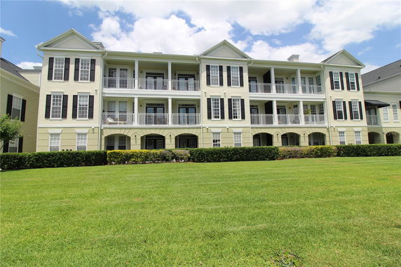 Front view of a three-story residential building with balconies.