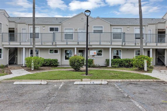 Front view of a two-story apartment building with balconies.