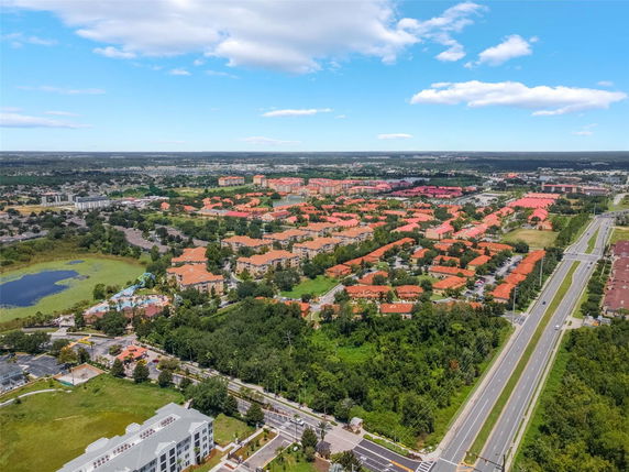 Panoramic view of a residential area with multiple housing units and a main road.