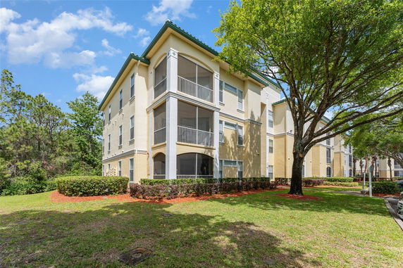 Front view of a multi-story apartment building with balconies.
