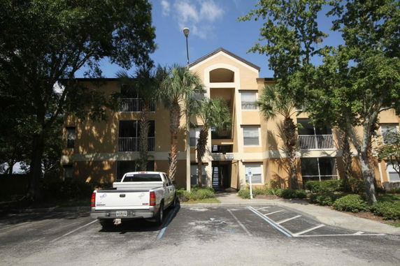 Front view of a multi-story residential building with a symmetrical facade and a central staircase.