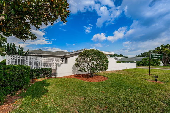 Front view of a single-story house with a decorative lattice wall.