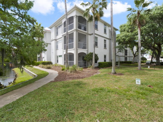Front view of a three-story residential building with multiple balconies.