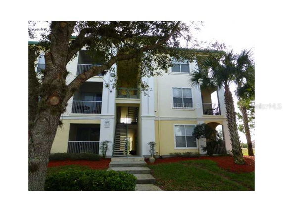 Front view of a multi-story apartment building with exterior stairs.