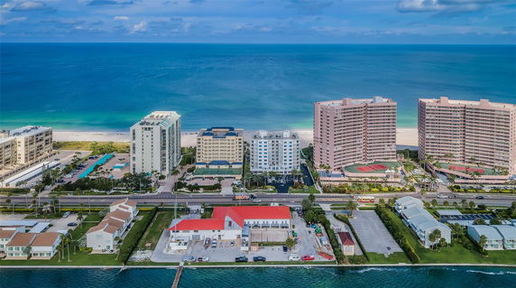 Aerial view of beachfront buildings overlooking the ocean.