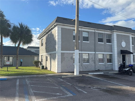 Front view of a two-story building with a gray exterior and white trim.