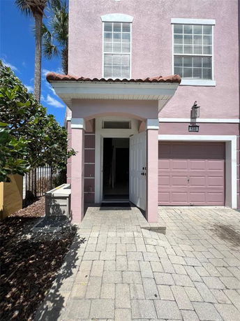Front view of a two-story house with a single garage and entrance.