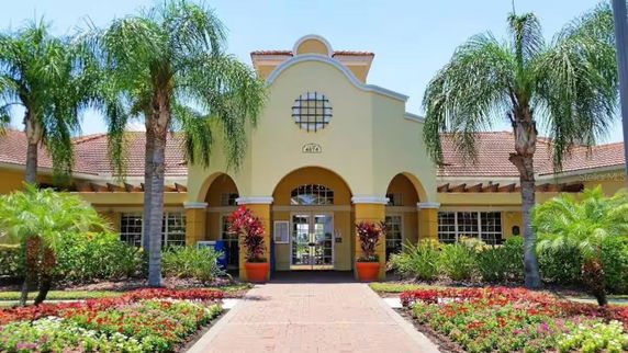 Front view of a building with arched entrances and a tiled roof.