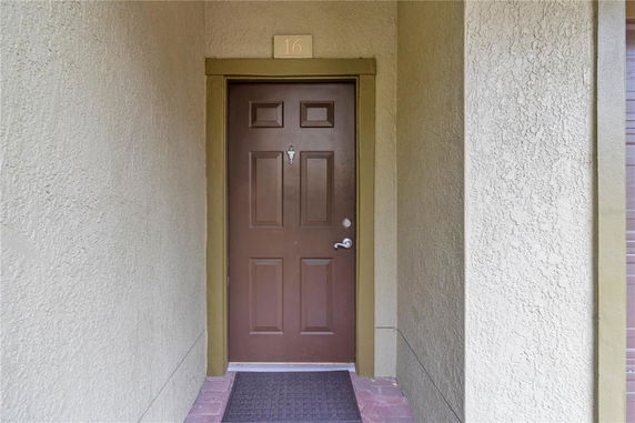 Close-up view of a house entrance with a brown door