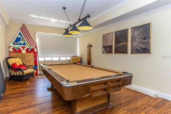 Recreation room with a pool table and seating area.