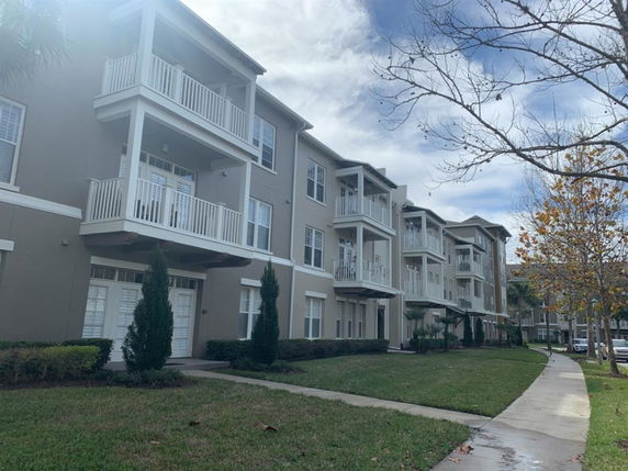 Front view of a multi-story residential building with balconies.