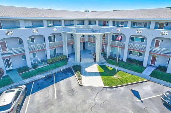 Front view of a multi-story residential building with balconies.