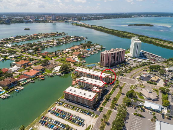 Aerial view of a coastal area with multiple residential buildings, roads, and waterways.