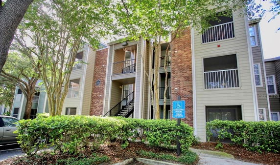 Front view of a multi-story apartment building with balconies.