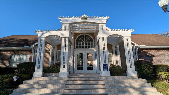 Front view of a building with a prominent entrance and white columns.