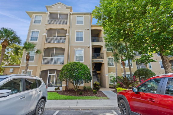 Front view of a multi-story residential building with balconies.