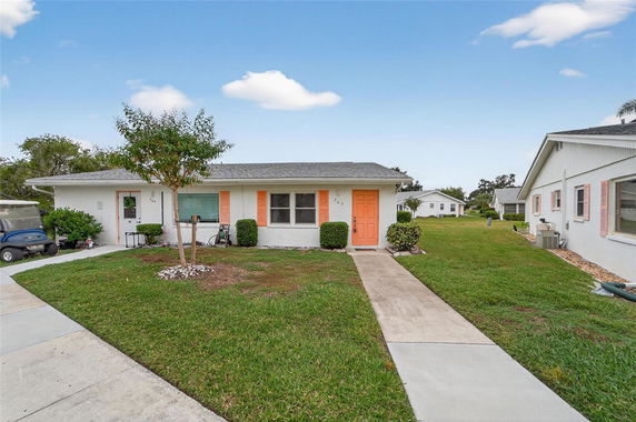 Front view of a single-story house with orange accents and a central door.